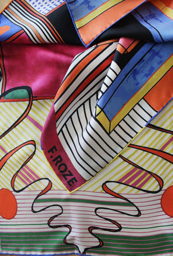 Elevate your style with the F.ROZE Sixties Wave, a luxurious 100% silk scarf that combines timeless elegance with a bold, modern twist. Printed in the UK and finished with meticulous hand-rolled edges, this exquisite accessory showcases an abstract design inspired by the vibrant, free-spirited energy of the 1960s. Rich in colour and movement, the “Sixties Wave” print flows effortlessly, making it a striking statement piece whether worn around the neck, in the hair, or tied to a bag. 