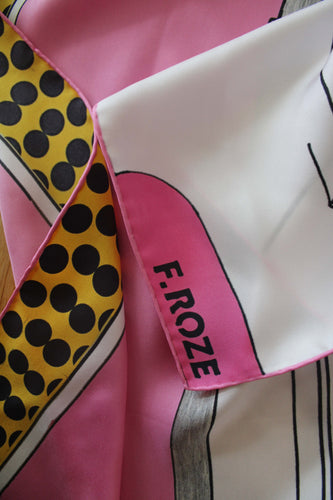 Step into a world of bold colour and artistic expression with the F.ROZE Sixties Door. Crafted from 100% pure silk and printed in the UK, this luxurious scarf features an abstract composition inspired by the geometric precision of Mondrian and the playful spontaneity of Miró. The vivid, modernist design is framed by delicate hand-rolled edges, showcasing exceptional craftsmanship. Whether draped, knotted, or displayed, the Sixties Door is a striking wearable artwork that brings a sophisticated edge. 